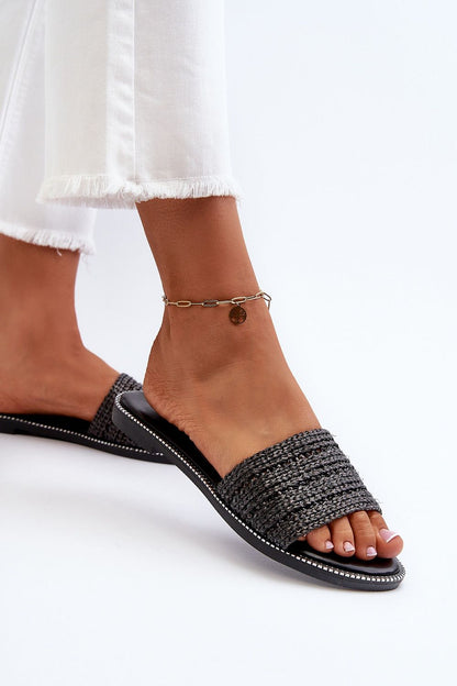 Stylish black braided flip-flops by Step in Style, showcased on a model's foot with an anklet, ideal for summer fashion.