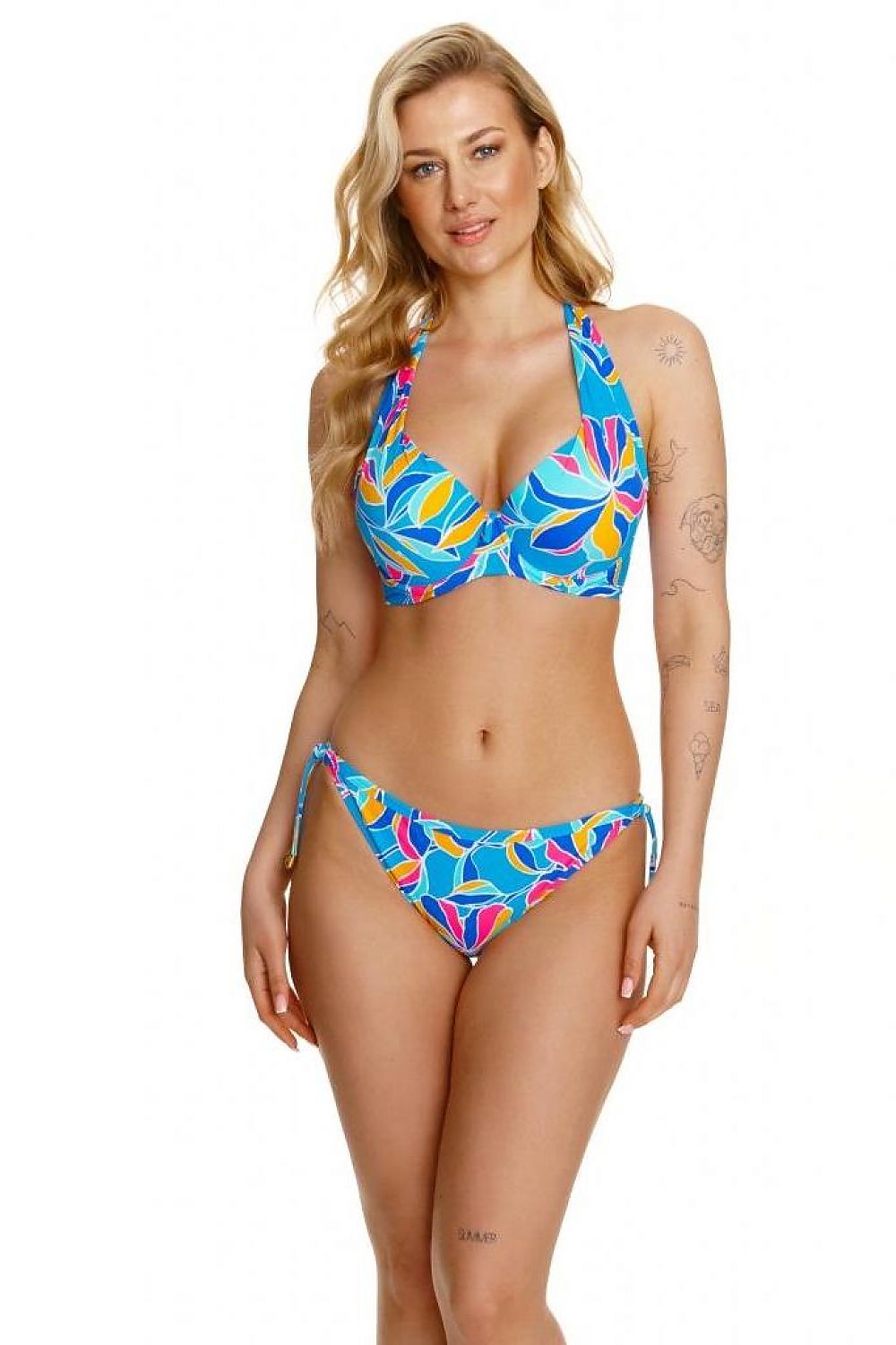 Elegant model showcasing the Lupo Line Floral High-Waisted Swimming Panties, adorned with vibrant floral patterns and gold accent ties, embodying luxury beachwear style.
