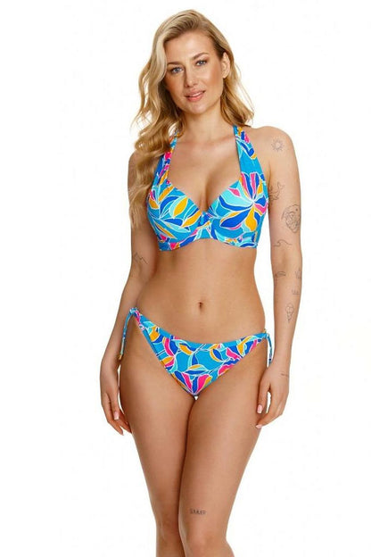 Elegant model showcasing the Lupo Line Floral High-Waisted Swimming Panties, adorned with vibrant floral patterns and gold accent ties, embodying luxury beachwear style.