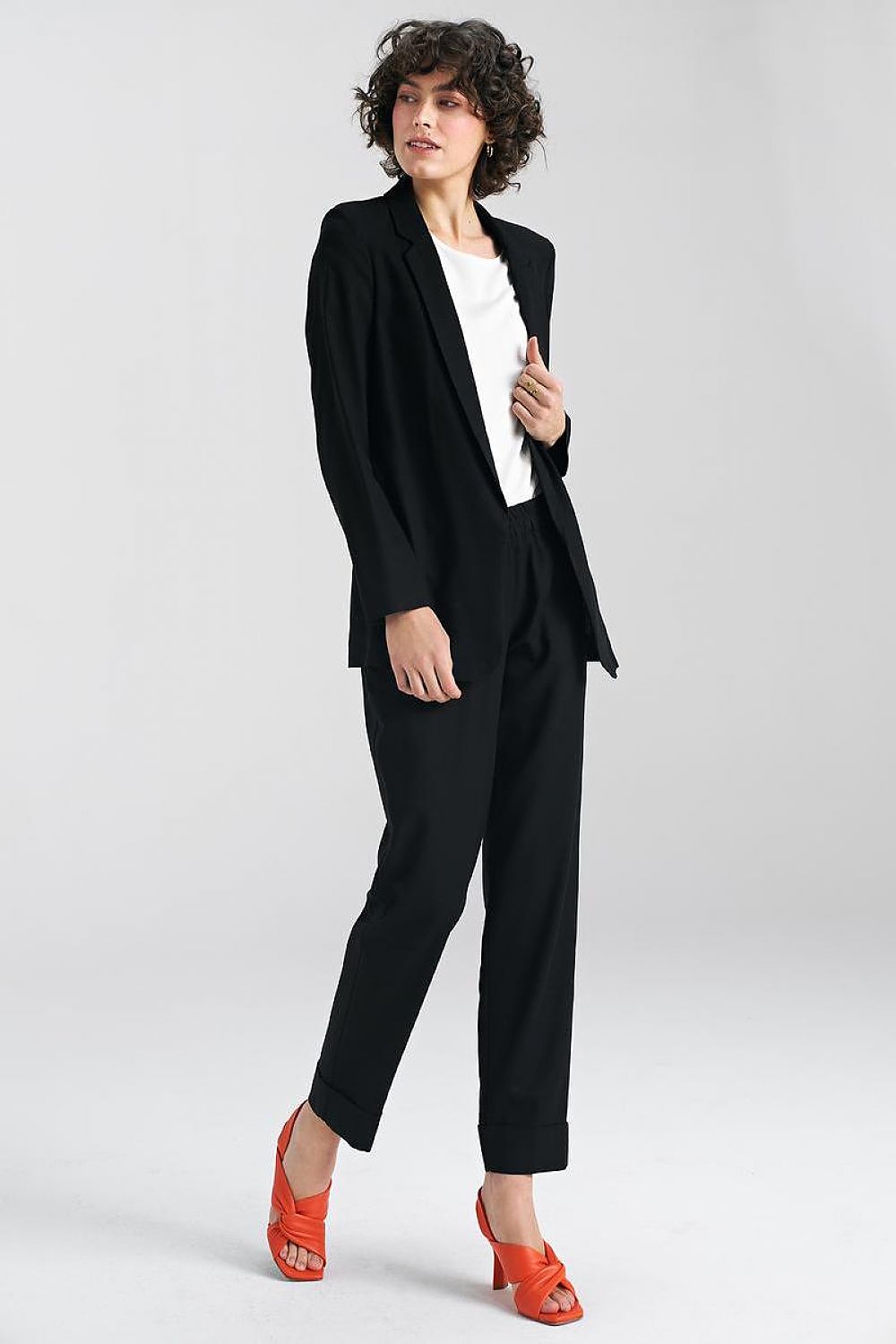 Sophisticated black trousers by Nife styled with a tailored blazer, exuding elegance in a modern professional look with striking orange heels.