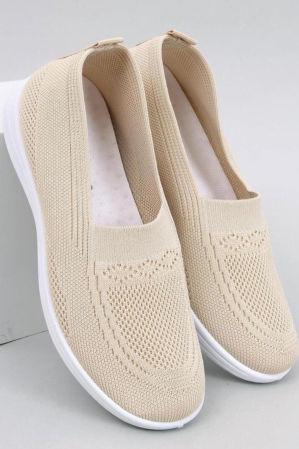 Inello Women's luxury slip-on sneakers featuring a breathable knit upper and springy white sole, ideal for stylish comfort on warm days.