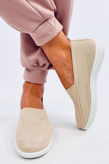 Elegant Inello women's slip-on sneakers featuring a springy sole, showcased on a model wearing stylish pink joggers. Perfect for comfort on warm days.
