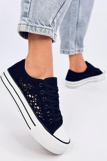 Inello Women's luxurious black lace-up sneakers showcasing a high sole and delicate fabric design, perfectly styled with rolled-up jeans.