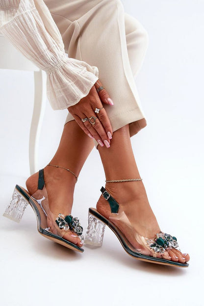 Elegant post heel sandals by Step in Style featuring a clear strap with decorative embellishments, set against a stylish outfit, showcasing luxury footwear perfect for any fashionable occasion.
