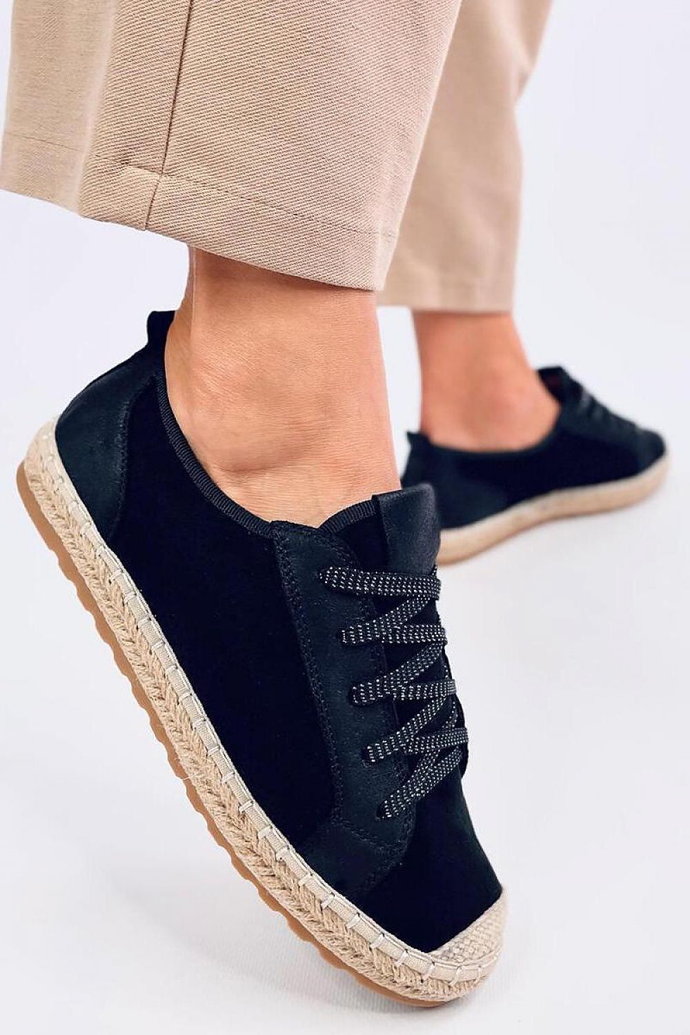 Stylish Inello women's lace-up espadrille sneakers with shimmering laces showcased on a model's foot, set against a minimal backdrop, perfect for spring and summer fashion.