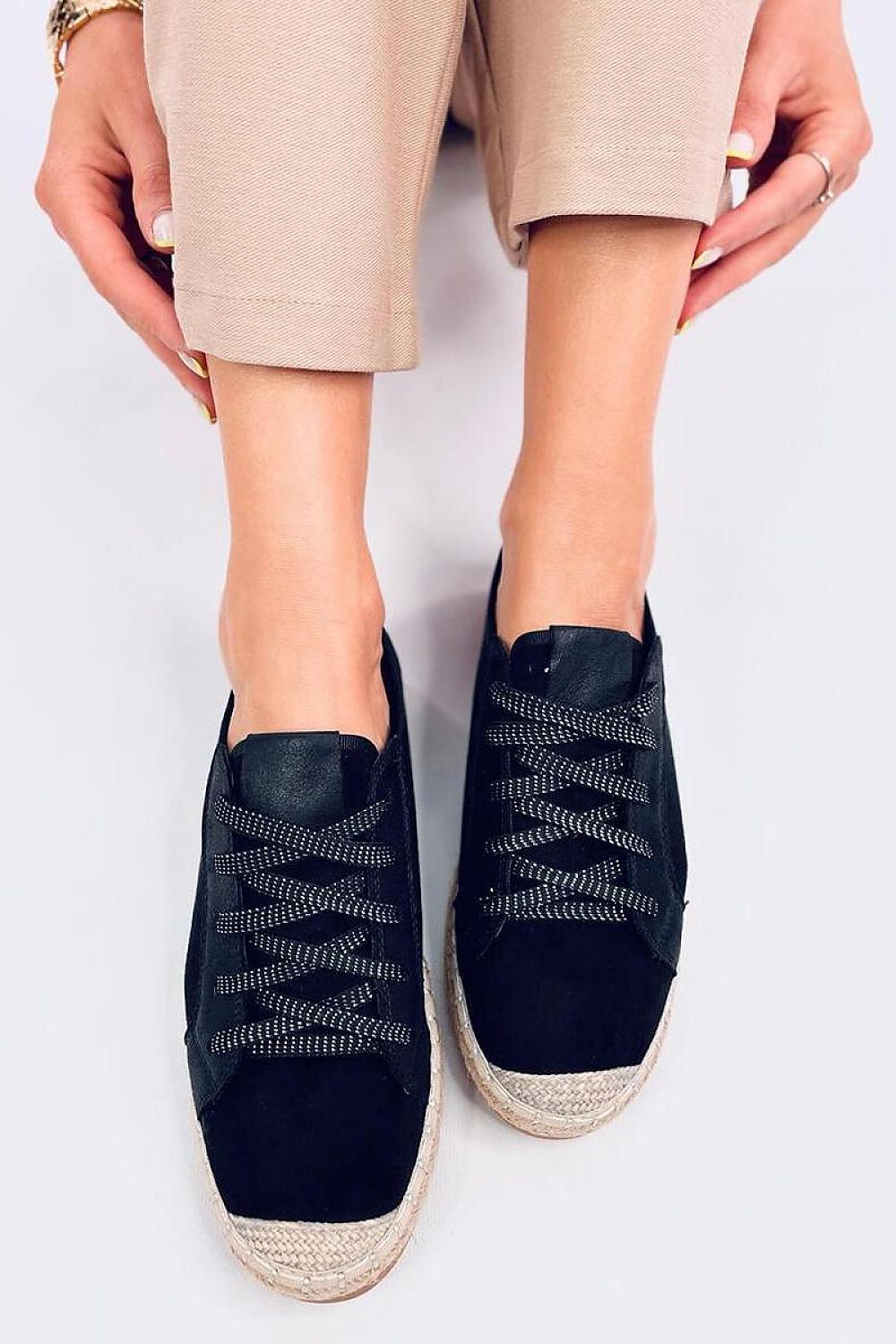 Close-up view of Inello women's black lace-up espadrille sneakers, highlighting the shimmering laces and elegant silhouette, ideal for a chic casual look.