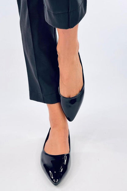 Elegant Inello patent leather ballet flats showcased on a woman's foot, featuring a graceful almond toe design, perfect for sophisticated dressing.
