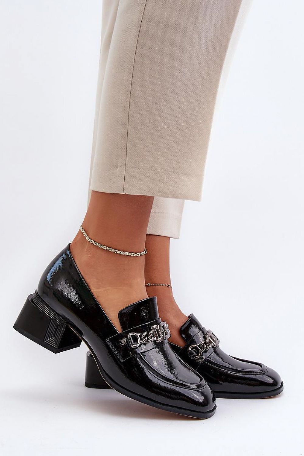 Elegant women's block heeled pumps by Step in style featuring a glossy black finish and embellished with a modern chain detail, ideal for sophisticated occasions.