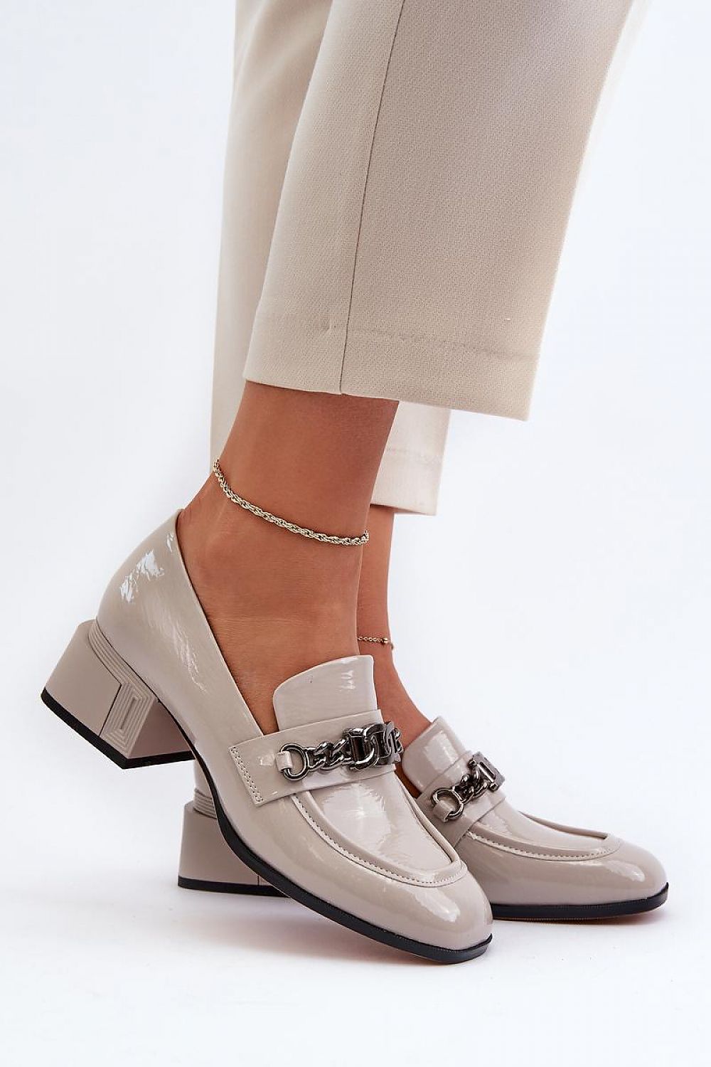 Elegant women's block heeled pumps featuring a modern square toe design and stylish chain detail, showcased by Step in Style.