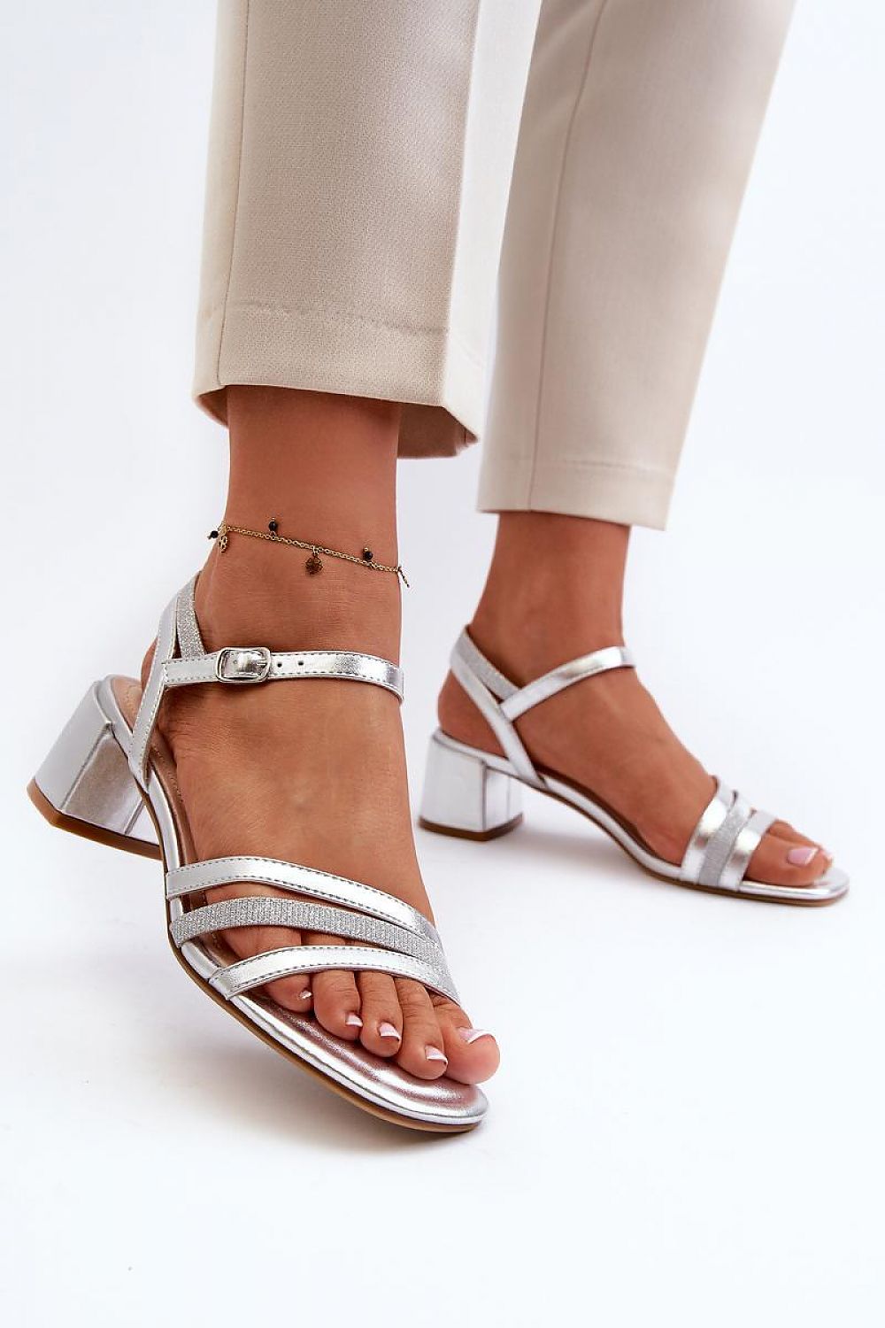 Elegant women's eco leather heel sandals by Step in Style, featuring a silver metallic finish with adjustable straps and a 5cm low block heel, styled for chic outings.