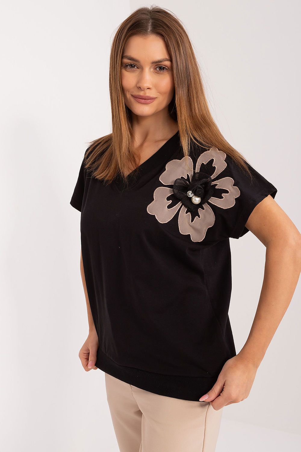 Stylish close-up of a black cotton blouse featuring an elegant floral design with zircon detailing, ideal for refined dressing by BFG.