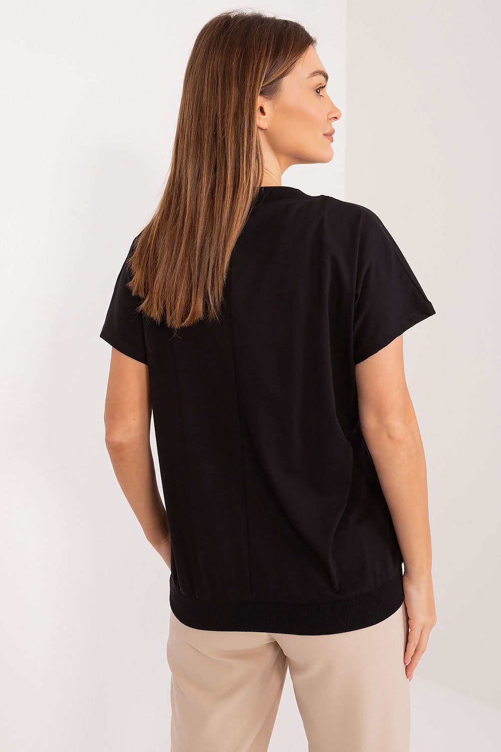 Sophisticated view of a woman wearing a stylish black cotton blouse from BFG, showcasing the elegant heart neckline and comfortable fit, perfect for both work and casual occasions.
