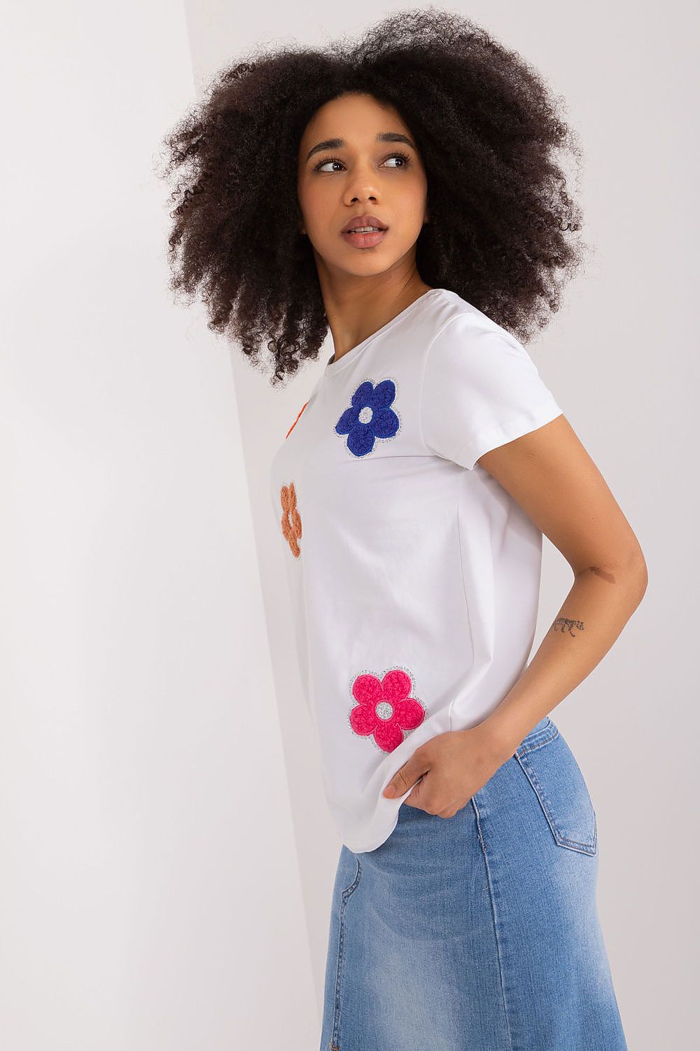 Side view of a trendy white floral blouse, highlighting its unique floral accents and sophistication, created by BFG.