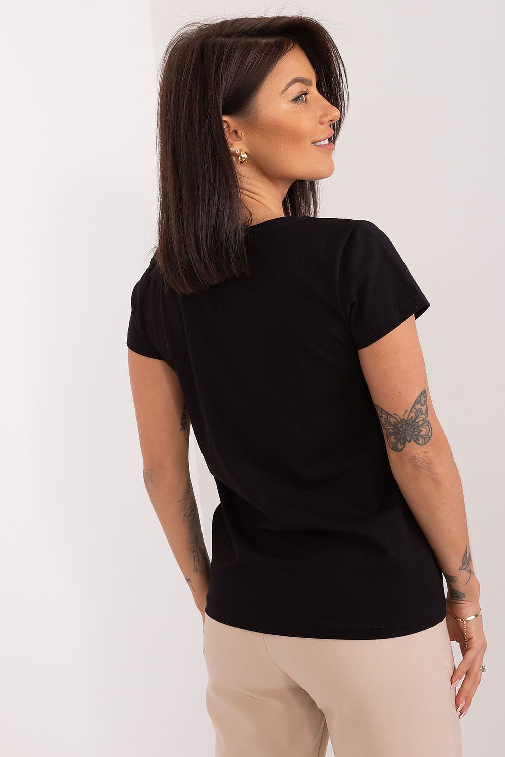 Sophisticated back view of a black short sleeve blouse with embroidered floral detail, paired with elegant trousers. Designed by BFG, highlighting the stylish and comfortable fit.