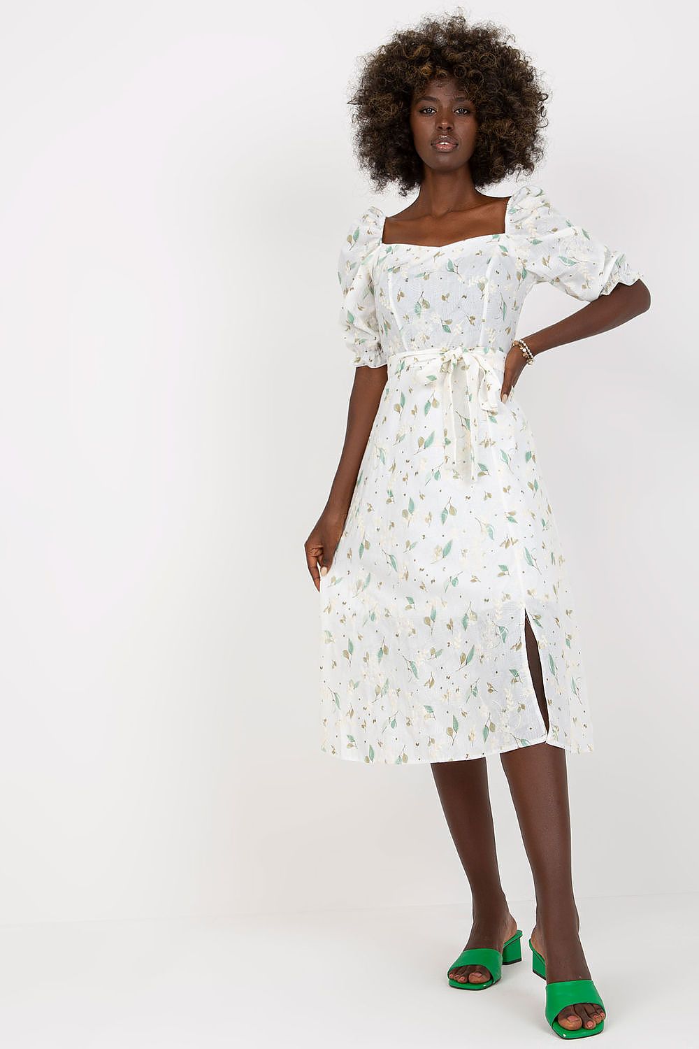 Stunning floral midi summer dress by Lakerta, adorned with delicate green floral prints and a luxurious silhouette. The model stands confidently in vibrant green sandals, embodying summer elegance.