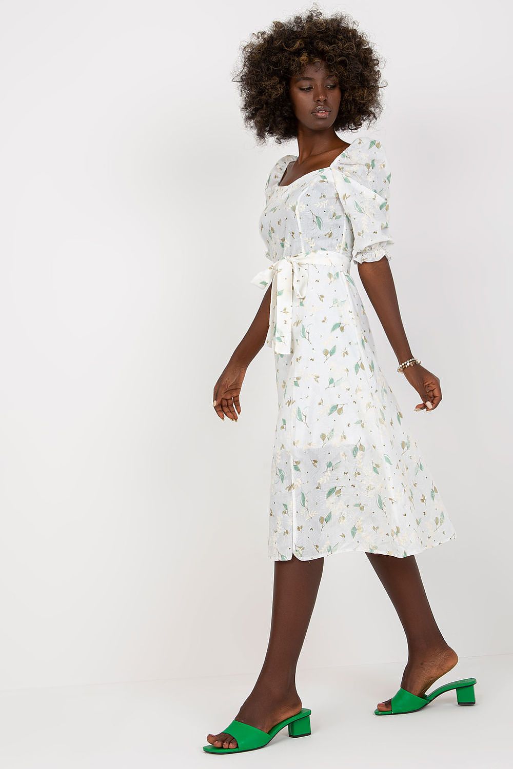 Elegant floral midi summer dress by Lakerta featuring ruffle sleeves, a tie belt, and a feminine silhouette, paired with stylish green block heeled sandals.