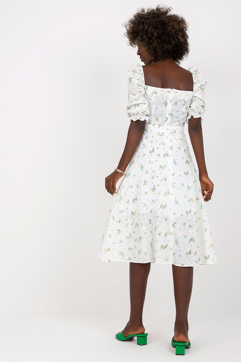 Back view of the Lakerta floral midi summer dress showcasing its beautiful lace detailing and ruffle sleeves, complemented by chic green block heeled sandals.