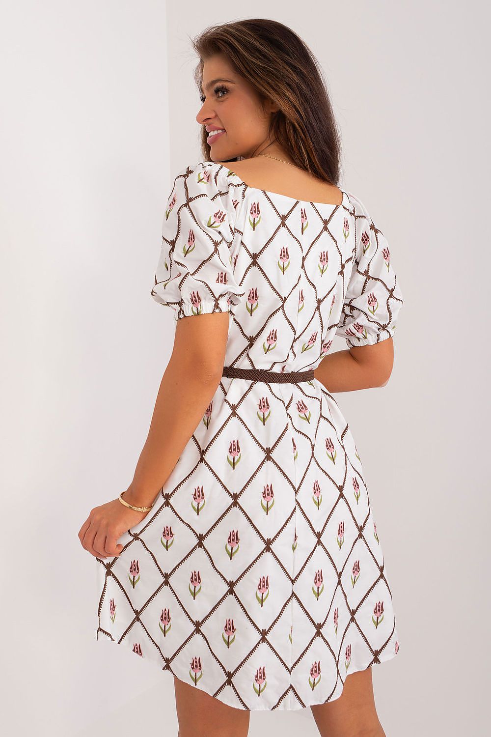 Back view of a luxurious floral embroidered cotton summer dress by Lakerta, highlighting the delicate puff sleeves and flattering flared design, perfect for fashionable summer occasions.