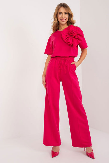 Elegant woman wearing Lakerta high rise cotton blend trousers in vibrant pink, styled with a matching top featuring a floral detail, perfect for casual and formal occasions.