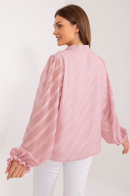 Back view of an elegant women's long sleeve button-down shirt by Lakerta in pastel pink, showcasing the sophisticated design and textured fabric, ideal for adding a touch of luxury to any outfit.