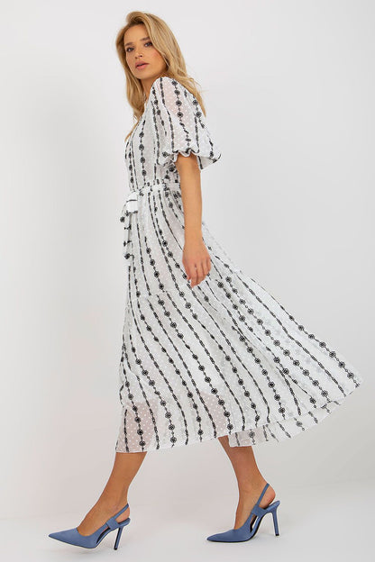 Chic side view of the Lakerta midi cotton dress, designed with a flattering tie belt and frill sleeves, perfect for stylish everyday wear.