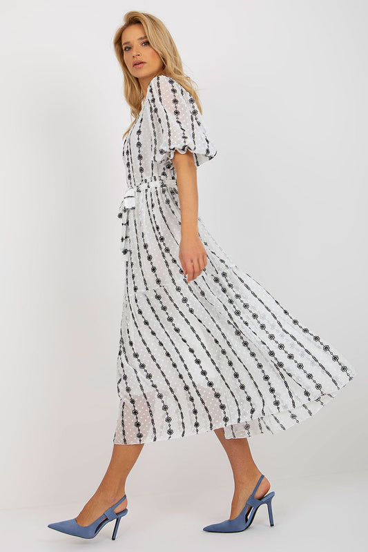Chic side view of the Lakerta midi cotton dress, designed with a flattering tie belt and frill sleeves, perfect for stylish everyday wear.