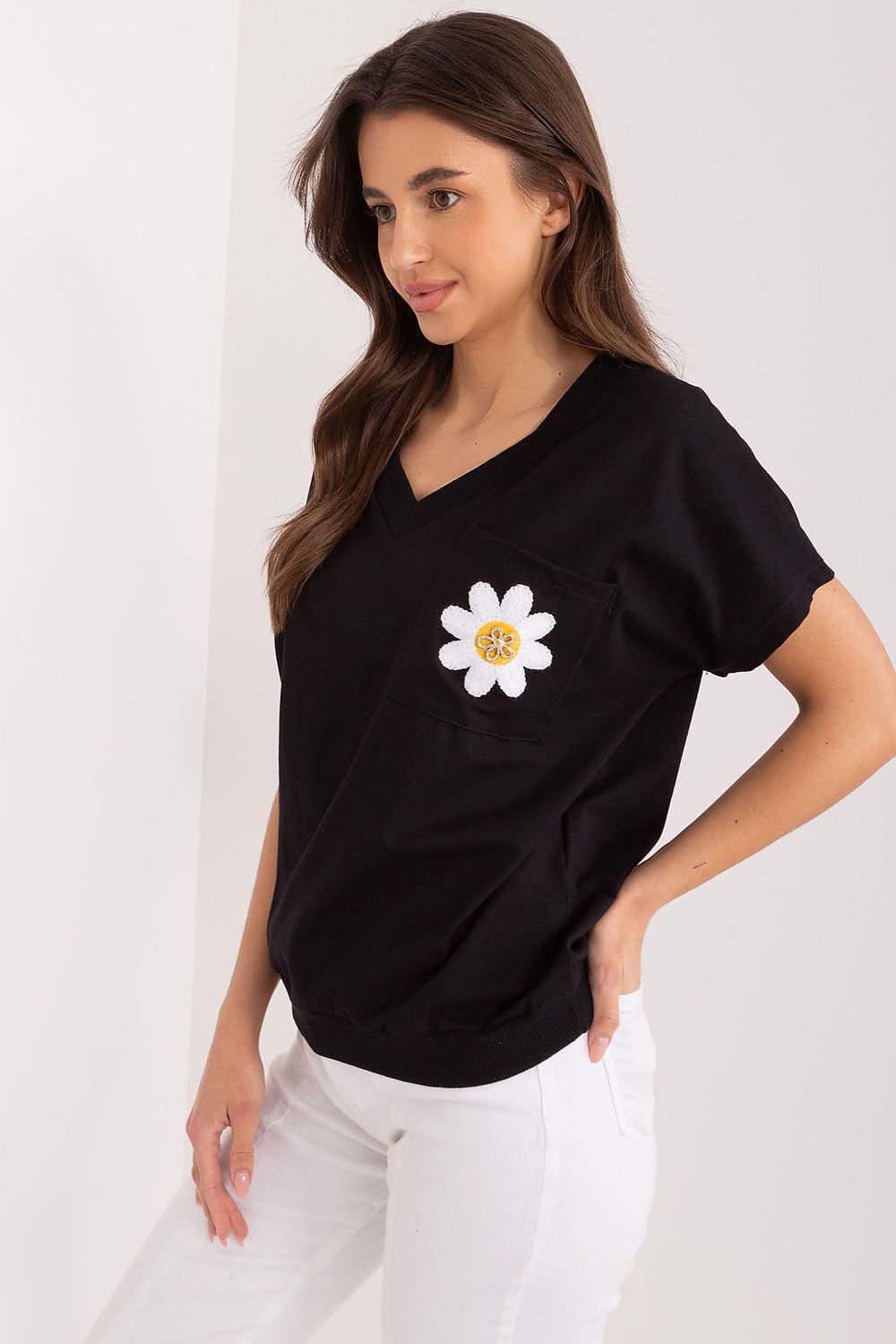 Sophisticated black cotton blouse by Rue Paris, showcasing a stylish embroidered flower on the pocket, perfect for effortless elegance.