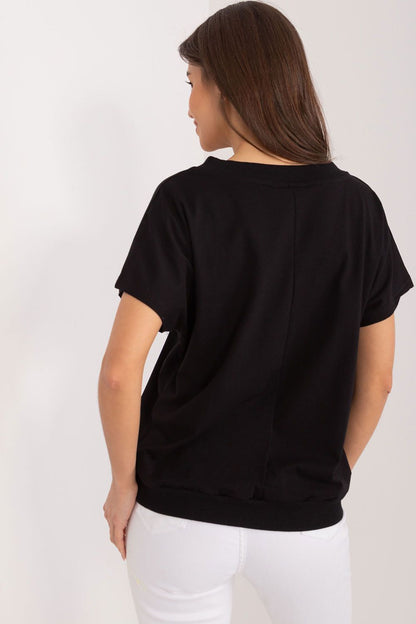 Stylish rear view of a black cotton blouse by Rue Paris, highlighting a modern silhouette with delicate embroidery, ideal for refined casual wear.