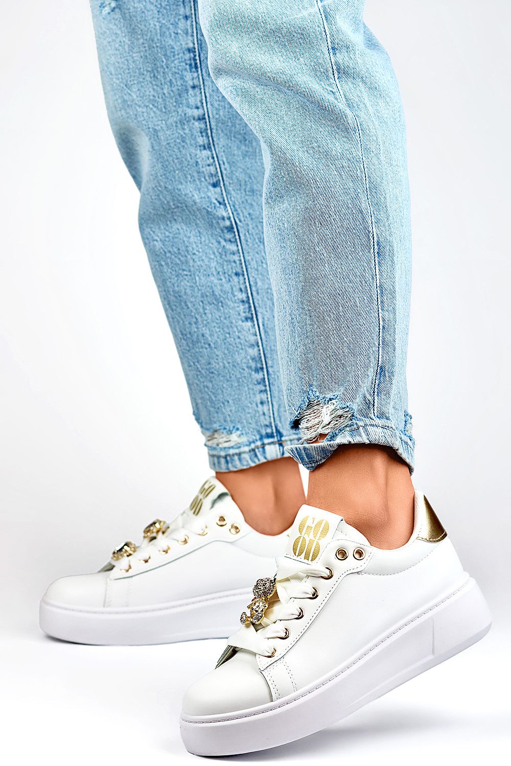 PRIMO Women's White Eco-Friendly Sport Shoes styled with jeans, showcasing a luxurious design and a comfortable 4.5 cm heel, perfect for fashionable athleticism.