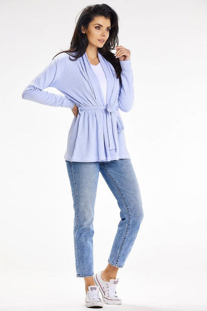 Sophisticated loose-fit cardigan in light blue with a belt and shawl collar, paired with denim jeans, showcasing spring and summer fashion by awama.