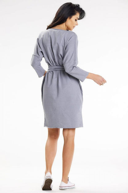 Back view of the chic grey daydress with a belt and roomy pockets from awama, designed for comfort and elegance during casual outings.