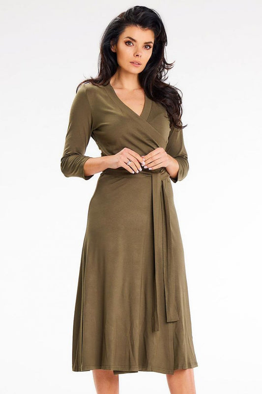 Elegant midi dress by Awama featuring a fitted, envelope-shaped top, waist belt, and 3/4 sleeves, perfect for date nights and family gatherings.