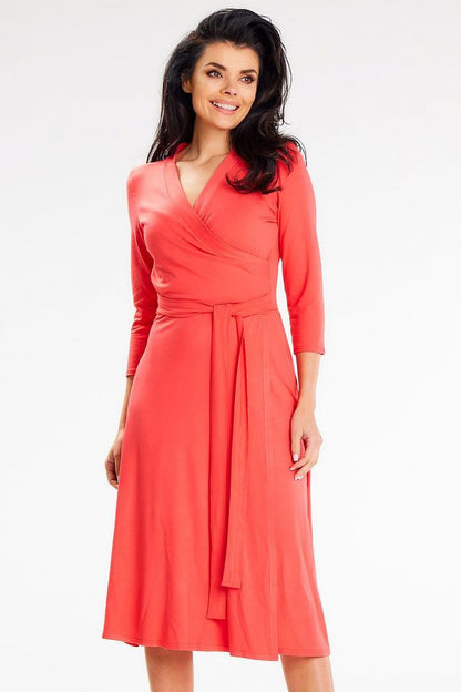 Vibrant coral midi dress by Awama with a fitted top and elegant waist tie, featuring 3/4 sleeves, ideal for glamorous outings.