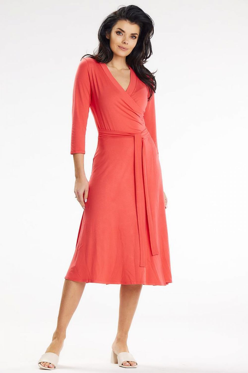 Chic coral midi dress with wrap design and waist belt, modeled by Awama. Ideal for enhancing your elegant wardrobe.