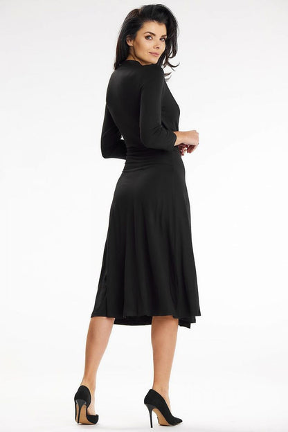 Stylish black midi dress with elegant back view and flowing design, highlighted by Awama. Perfect for a night out or special events.