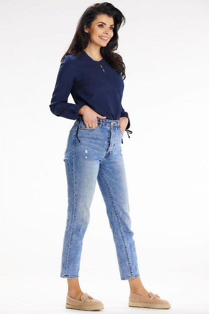Woman posing confidently in a navy Awama shirt and high-waisted jeans, epitomising modern elegance and style for versatile occasions.