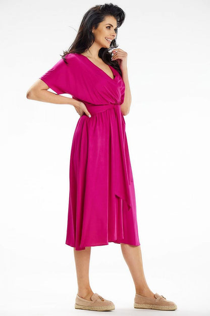Model wearing the flared midi dress with kimono sleeves by Awama, perfect for both work and casual outings.