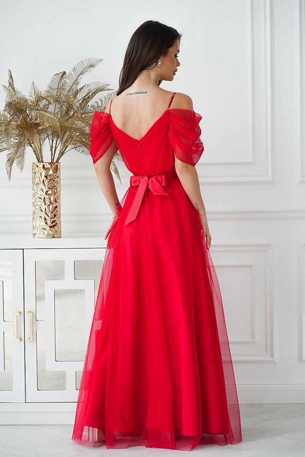 Back view of the long Spanish-style dress by Bicotone with covered zipper, emphasizing its sophisticated silhouette and lining.