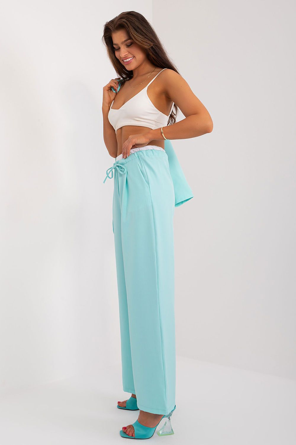 Stylish wide-leg palazzo pants by Italy Moda elegantly draped, offering a sophisticated look suitable for both casual and formal events.