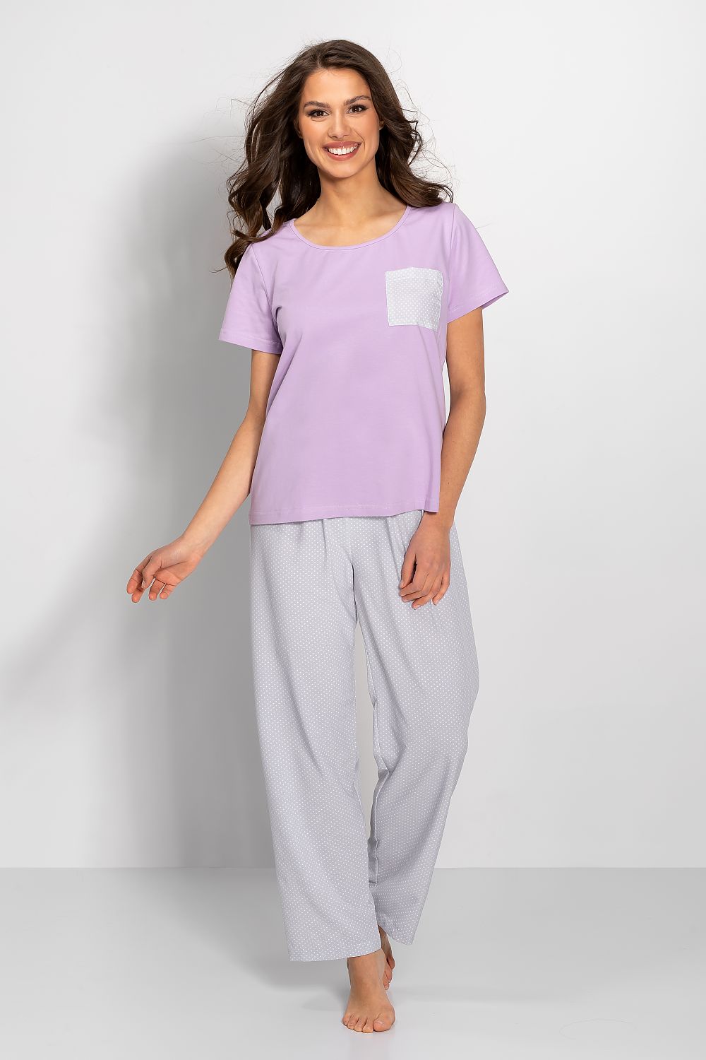 Elegant women's luxury lilac pyjama set featuring a short-sleeved blouse and patterned long pants with decorative bow details, perfect for stylish evening comfort.