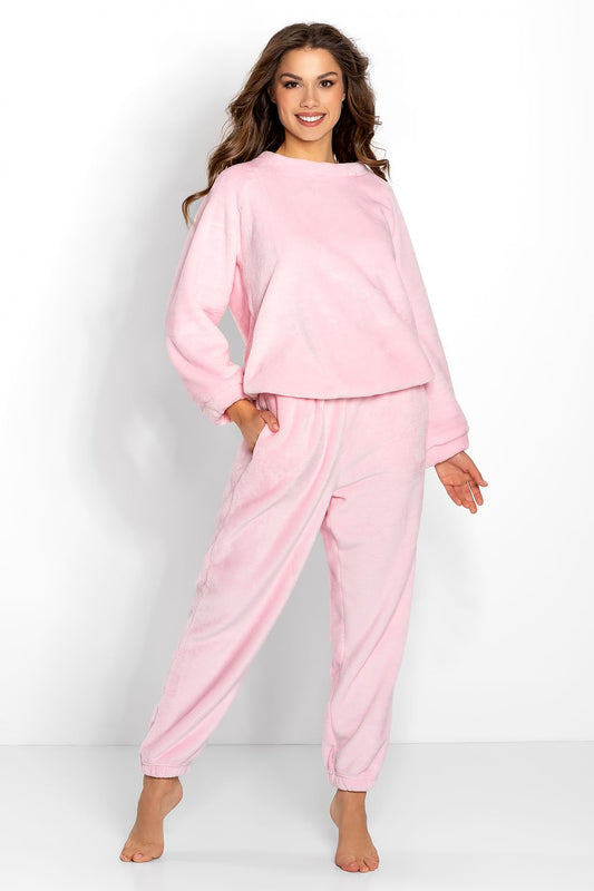 Elegant pink velour oversize tracksuit dress for women, featuring a soft microfleece knit fabric, stylish long-sleeve sweatshirt, and matching pants, showcased in a luxurious setting.