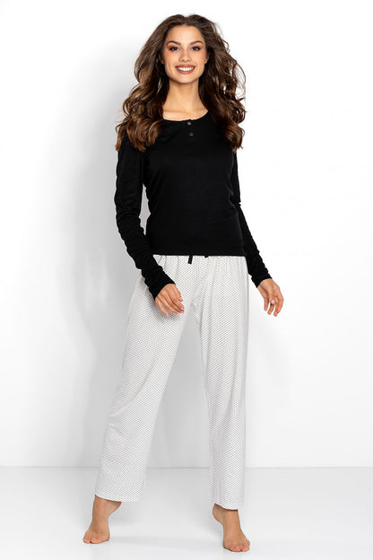 Elegant women's black and ecru pyjama set featuring a classic long sleeve top and stylish loose-fit trousers with a black bow detail at the waist. Perfect for luxury lounging.