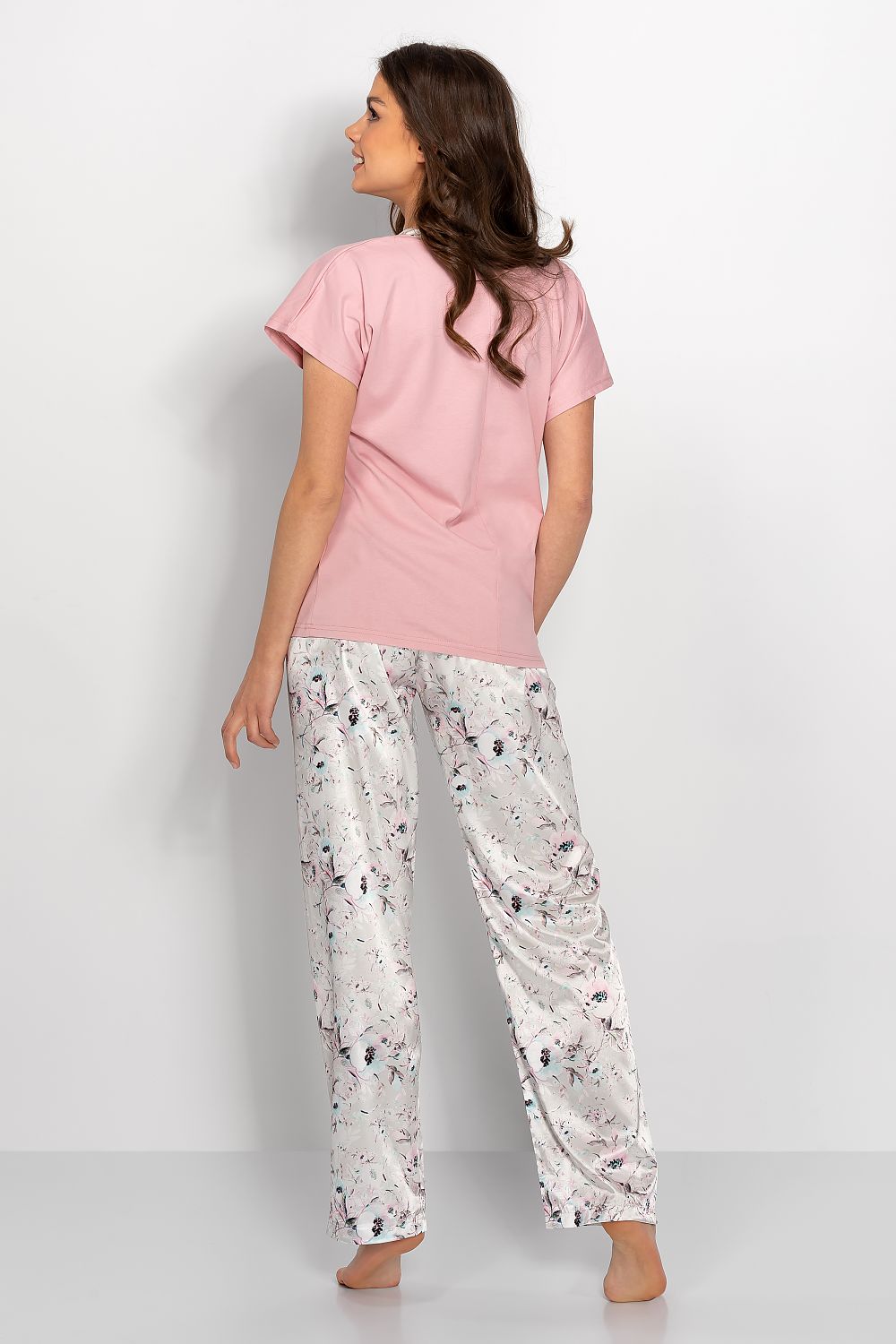 Elegant Floral Satin Two-Piece Pyjamas Set in Powder Pink and Silver by Momenti Per Me, showcasing a back view of loose-fitting satin trousers adorned with a delicate floral motif and a powder pink T-shirt.