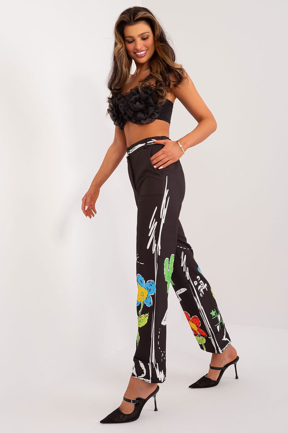 High-waisted women's trousers by Italy Moda featuring a vibrant, colorful print. The wide leg style adds a touch of luxury to your casual outfits.