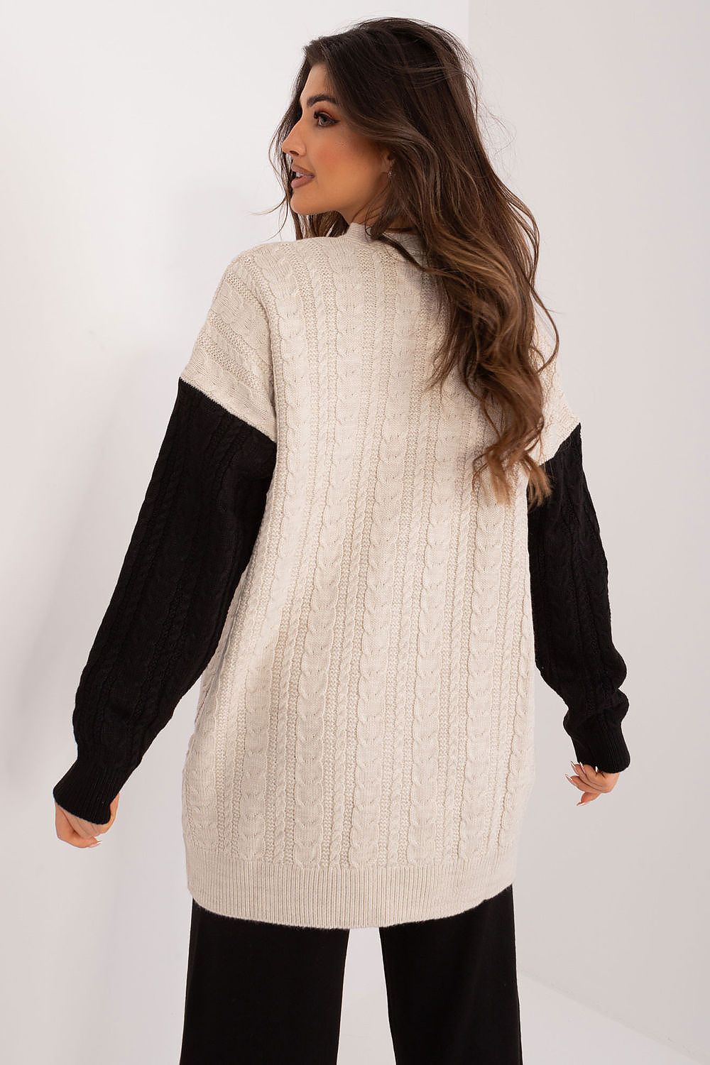 Badu's chic unbuttoned cardigan showcasing contrasting long sleeves and a heart neckline, ideal for versatile comfort.