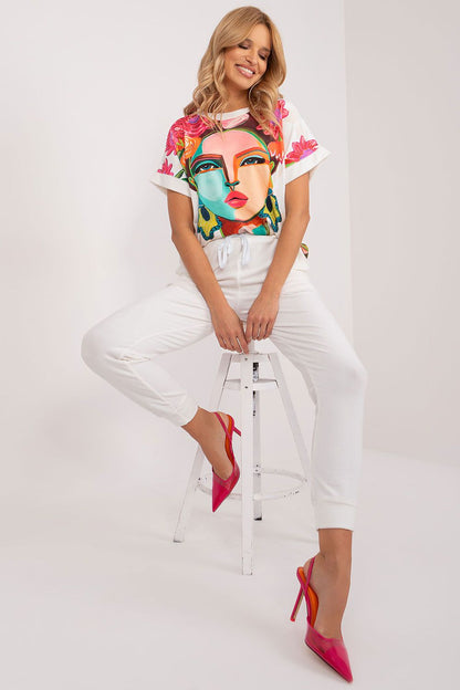 Close-up of the soft polyester blouse from the Rue Paris luxurious velour set, showcasing its unique print and short sleeves.