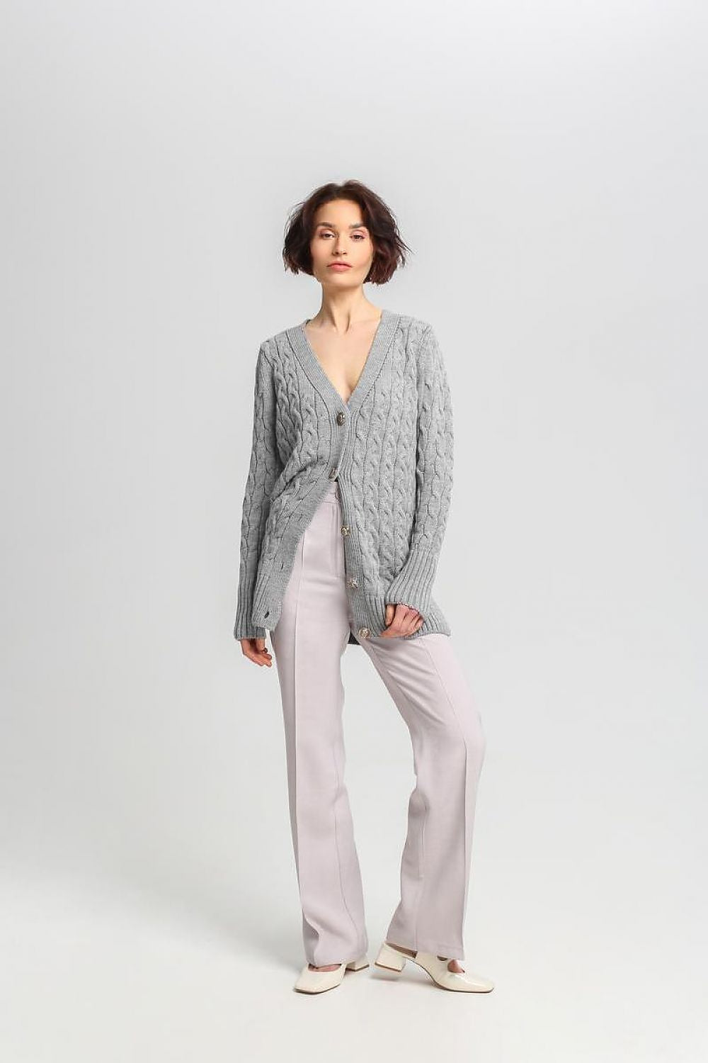 Stylish MKM long cardigan presented in a flattering fit, accentuated by distinctive crest buttons and checkered patterns.