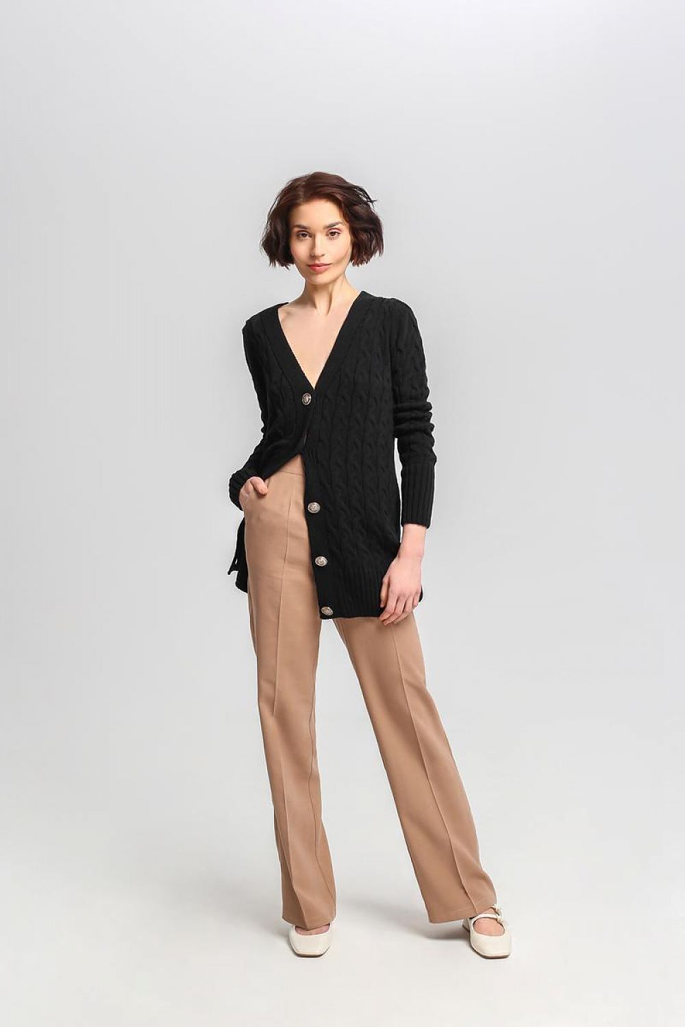 Fashion-forward MKM long cardigan styled with crest buttons, highlighting its fashionable checkered weave and versatility.