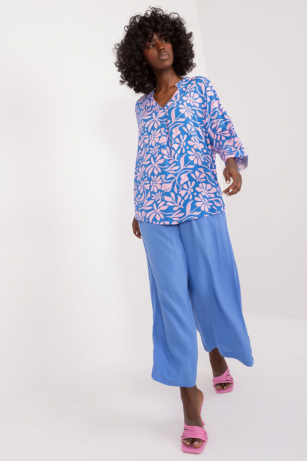 Model wearing Sublevel's exquisite soft viscose blouse featuring a sweetheart neckline and lively colours, styled for a chic everyday look.