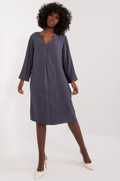 Model wearing the elegant oversized V-neck daydress by Sublevel, demonstrating its flowy silhouette and stylish pockets for a practical yet fashionable look.